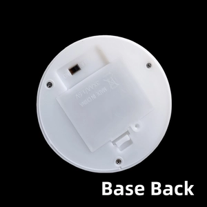 Detail view of the white round base with battery compartment and toggle switch for LED lamp