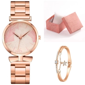 Close-up of rose gold watch and star bracelet set with palm leaf dial in a pink gift box