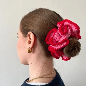Pink and red ruffle knit hair scrunchie shown on a ponytail with a vintage look