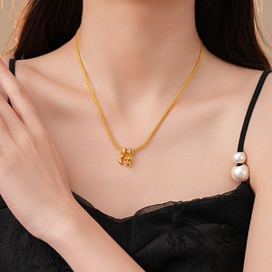 Golden minimalist crescent moon necklace with zircon bear pendant on female model neck