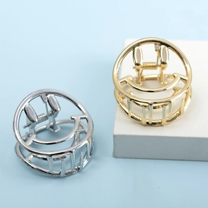 Minimalist metal hair claws with hollow smiley face design in gold and silver finish