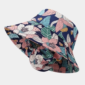 Detail of navy blue sun hat with floral pattern and wide neck protective flap