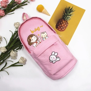 Close-up of pink canvas pencil case featuring a cute cartoon girl and mini backpack design