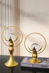 Close-up of dual lotus crystal balls on gold metal stands for home decor
