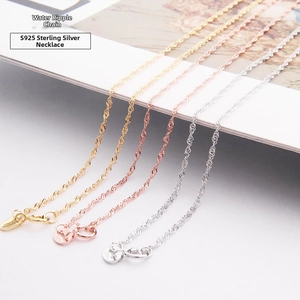 Macro shot of S925 sterling silver water wave chains in gold, rose gold and silver finish