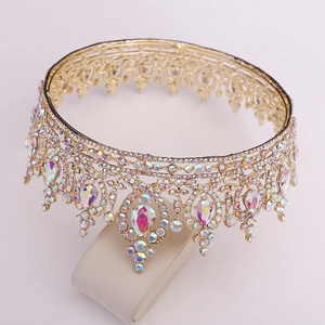 Detailed shot of a gold bridal crown with iridescent rhinestones and heart-shaped crystals
