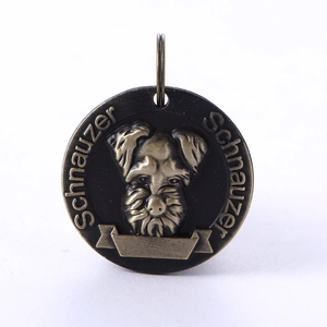 Detailed close-up of antique bronze schnauzer dog tag with embossed pet portrait