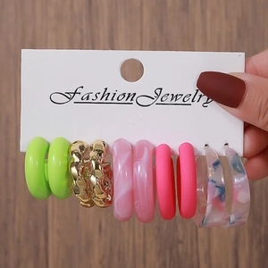 Five pairs of acrylic and metal hoop earrings in vibrant neon green and marble patterns