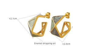 Macro detail of geometric titanium steel earrings with enamel dripping oil art