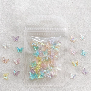 Macro shot of 3D iridescent resin butterfly charms for nail art in mixed pastel colors