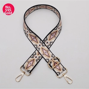 Close-up of ethnic geometric pattern strap with golden metal hardware and adjustable slider