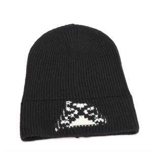 Detail view of black knit beanie with white butterfly jacquard pattern and folded cuff