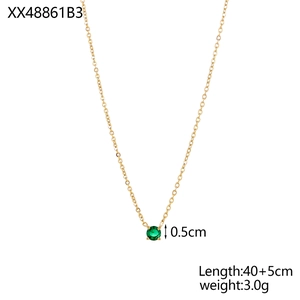 Detail of gold necklace featuring a 0.5cm round green gemstone pendant in claw setting
