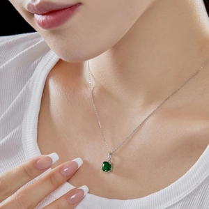 Close-up of elegant S925 silver necklace with square emerald green zircon pendant on model