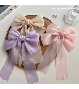 Elegant organza bow hair clips in purple pink and cream with long ribbons detail