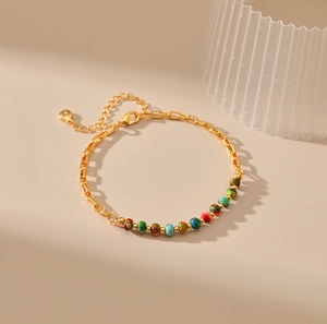 Detailed macro view of 18K gold-plated chain bracelet with colorful gemstone beads