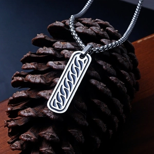 Silver stainless steel rectangular pendant necklace on a pine cone display