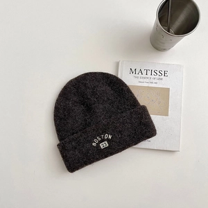 Detail of wool blend knit beanie featuring white BOSTON 23 embroidery in dark brown