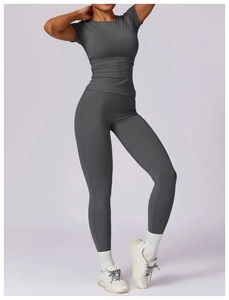 Detailed view of dark grey slim-fit yoga short sleeve tee and high-waist sports leggings