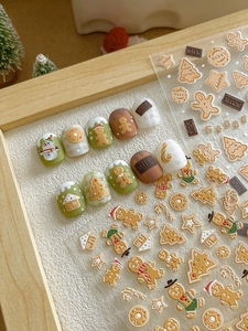 Detail view of 3D embossed Christmas nail stickers with gingerbread man and tree designs