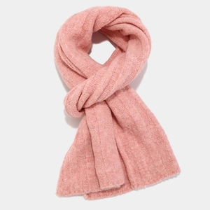 Detail of pink cable knit scarf with vertical ribbed texture and soft yarn fabric