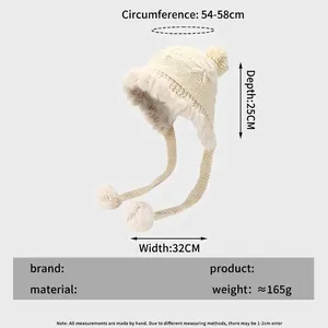 Winter knit trapper hat with pom-poms, faux fur lining, and ear protection in beige color