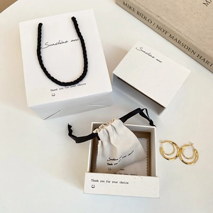 Minimalist white jewelry gift set with paper bag, box, and beige drawstring pouch