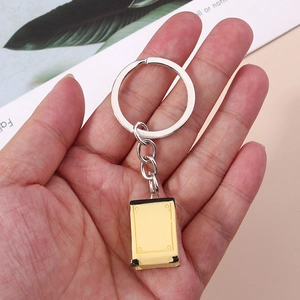 Creative miniature yellow safe box keychain with silver metal ring held in hand