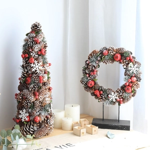 Christmas pine cone tree and matching berry wreath set with snowy festive decorations