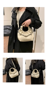 Detail of soft cream ruched cloud bag with stylish beaded chain and shoulder strap