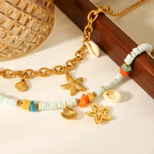 Detailed close-up of 18k gold starfish and shell charms on beach vacation necklaces