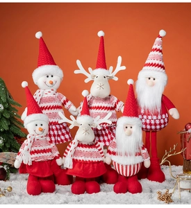 Detailed group display of plush Santa, reindeer, and snowman dolls on white snow surface