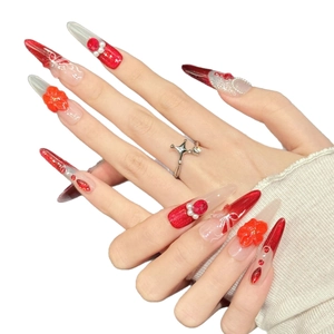 Luxurious handmade press-on nails featuring red gradient with 3D floral accents and rhinestones