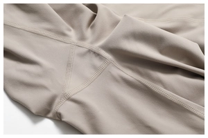 Macro detail of high-density brushed fabric with reinforced stitching on yoga pants