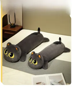 Detail of dark grey cat plush pillows in 110cm and 90cm sizes on a cozy bed