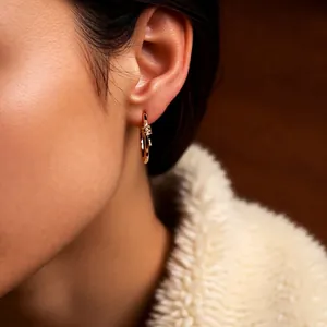 18k gold plated round hoop earrings with twisted knot design and zircon inlay on earlobe