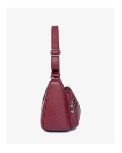 Side view of burgundy litchi grain leather shoulder bag with adjustable strap and zippers