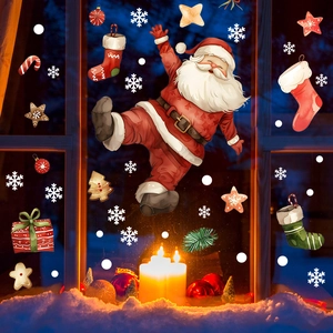 Christmas window clings featuring Santa Claus and snowflakes in a cozy candlelit setting