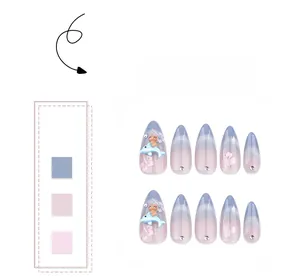 Close-up of almond blue cat-eye nails with 3D dolphin, bear charms and glitter accents