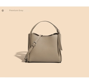 Detailed macro of the premium grey pebble leather bucket bag with top handle and strap