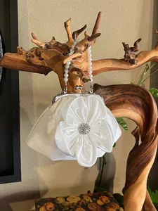 Elegant white satin evening handbag with a large 3D flower and pearl handle