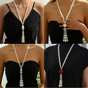 Detailed macro view showing four elegant long pearl tassel necklace designs with varied charms