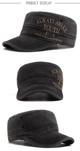 Macro shot of washed dark grey flat top military cap with detailed yellow embroidery