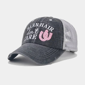 Detail of vintage washed baseball cap with pink embroidery and breathable mesh back