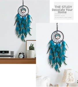 Detail of tree of life dreamcatcher featuring peacock blue feathers and woven beads