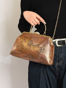 Vintage embroidery kiss-lock handbag with ornate floral pattern and chain strap