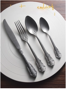 Detail of vintage relief patterns on retro 304 stainless steel cutlery set handles
