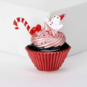 Macro shot of a Christmas cupcake brooch with pink cream, snowman and enamel finish