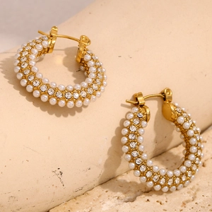 Detail of 18K gold-plated hoop earrings with rows of white pearls and sparkling zircons
