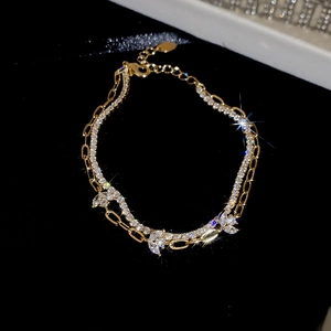 Detail of 18k gold plated double layer bracelet with zircon stones on black background